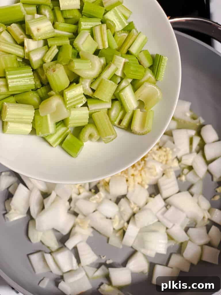 Filipino Pancit Bihon Noodles 7 process shot of adding celery to pan