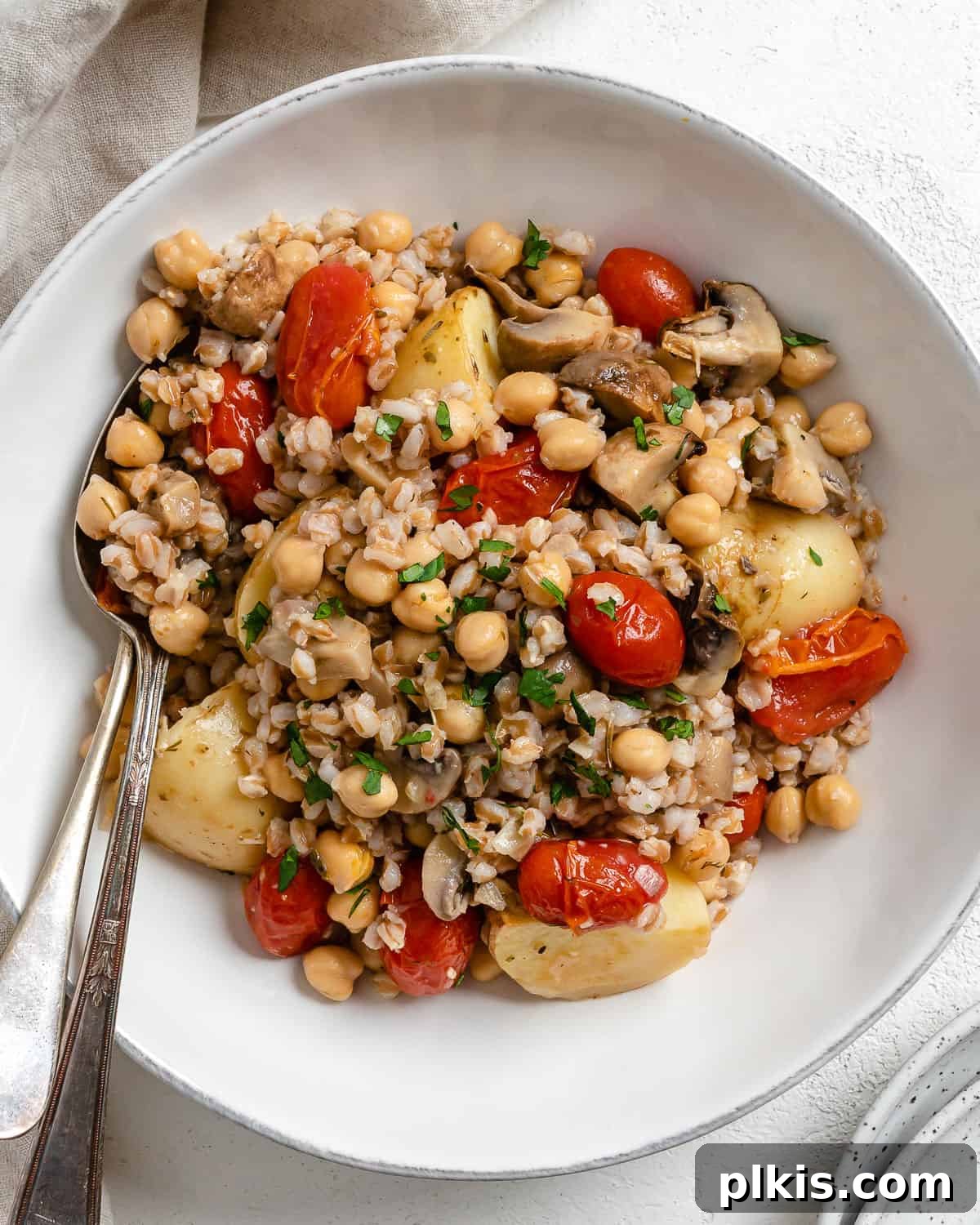 Easy Farro Recipe with Roasted Vegetables plated on a white plate, showcasing golden farro and colorful roasted vegetables