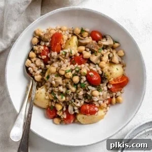 completed Easy Farro Recipe with Roasted Vegetables plated on a white plate