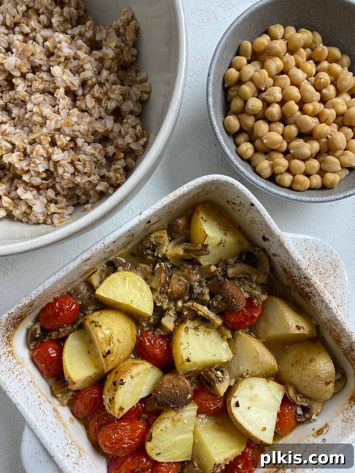 Ingredients for Easy Farro Recipe with Roasted Vegetables in three separate containers: roasted veggies, cooked farro, and garbanzo beans