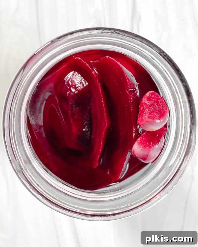 Small Batch Pickled Beets beautifully placed in a mason jar against a white background, ready for enjoyment.