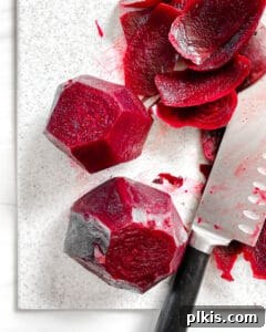 Process of slicing beets against a white background, showing even cuts.