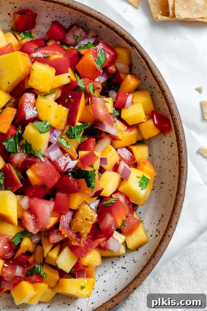 Sweet & Simple Peach Salsa 5 A close-up of a bowl filled with Easy Peach Salsa, showcasing the vibrant colors and fresh ingredients.