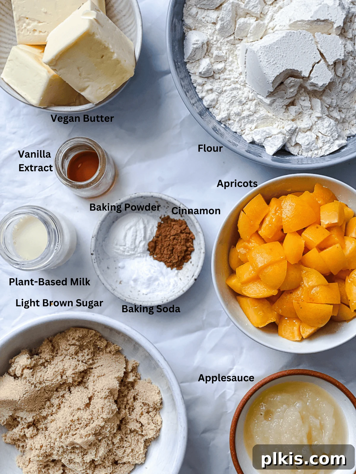 Golden Apricot Delights 3 Carefully measured ingredients for Apricot Cookies displayed on a pristine white surface, ready for baking.