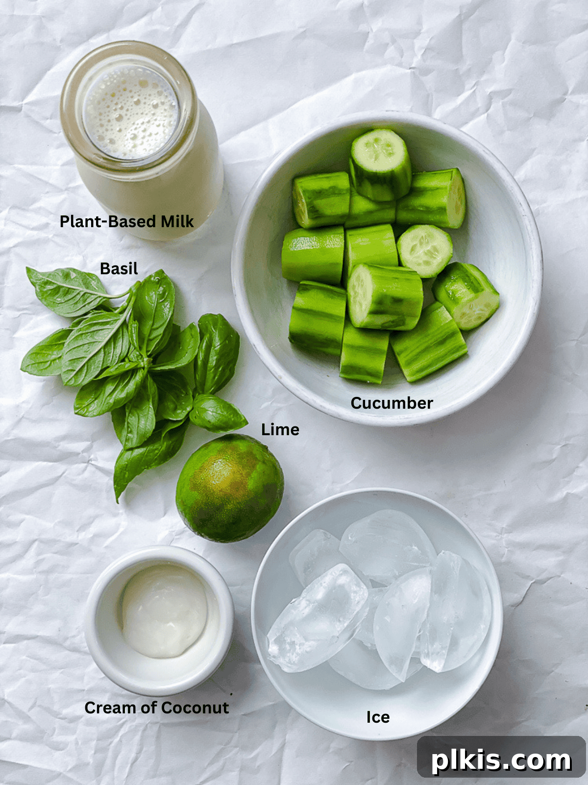 Cool Cucumber Bliss 3 Ingredients for a cucumber smoothie laid out on a white surface