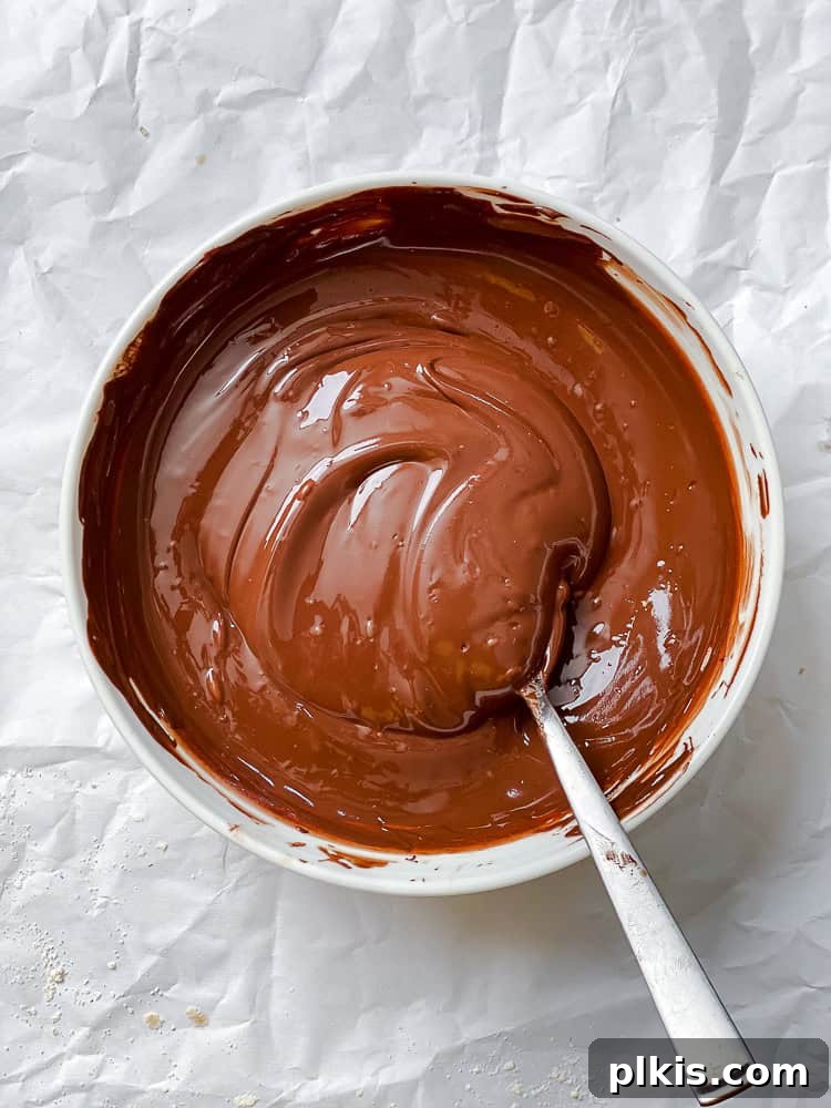 Protein-Packed Chocolate Peanut Butter Pops 4 Melting vegan chocolate chips in a bowl