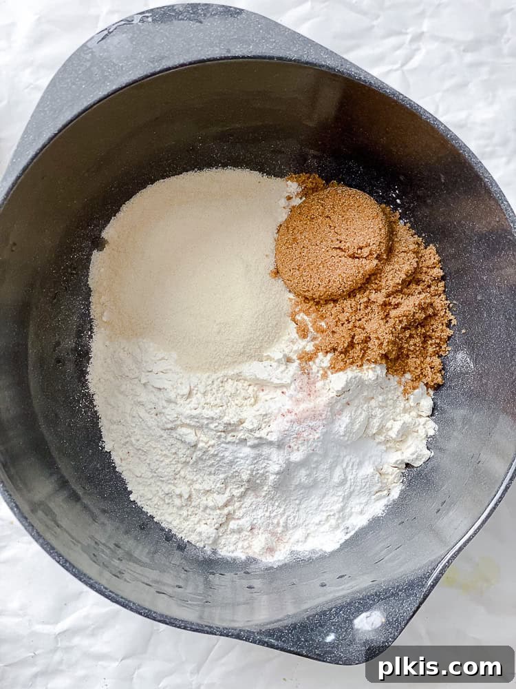 Golden Apricot Quick Bread 5 Process shot showing wet ingredients being added to the dry ingredients in a bowl, just before mixing.