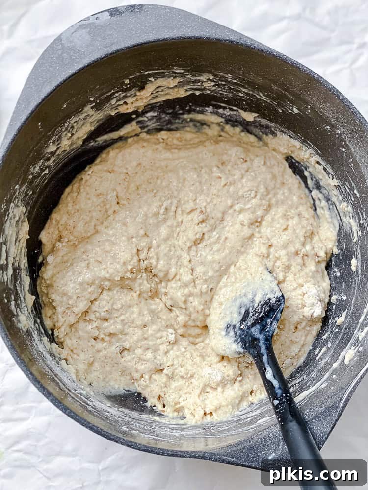 Golden Apricot Quick Bread 6 Process shot of mixing wet and dry ingredients in a bowl to form the apricot bread batter.