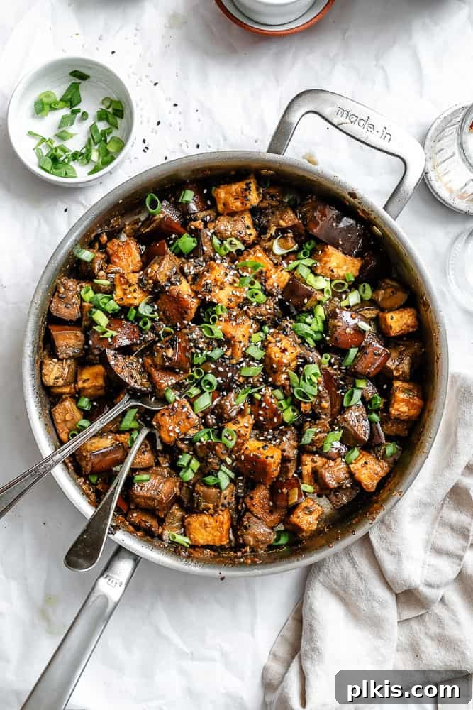 Sweet Chili Glazed Eggplant and Tofu 2 A vibrant plate of Sticky Eggplant and Tofu, beautifully garnished and ready to be served.