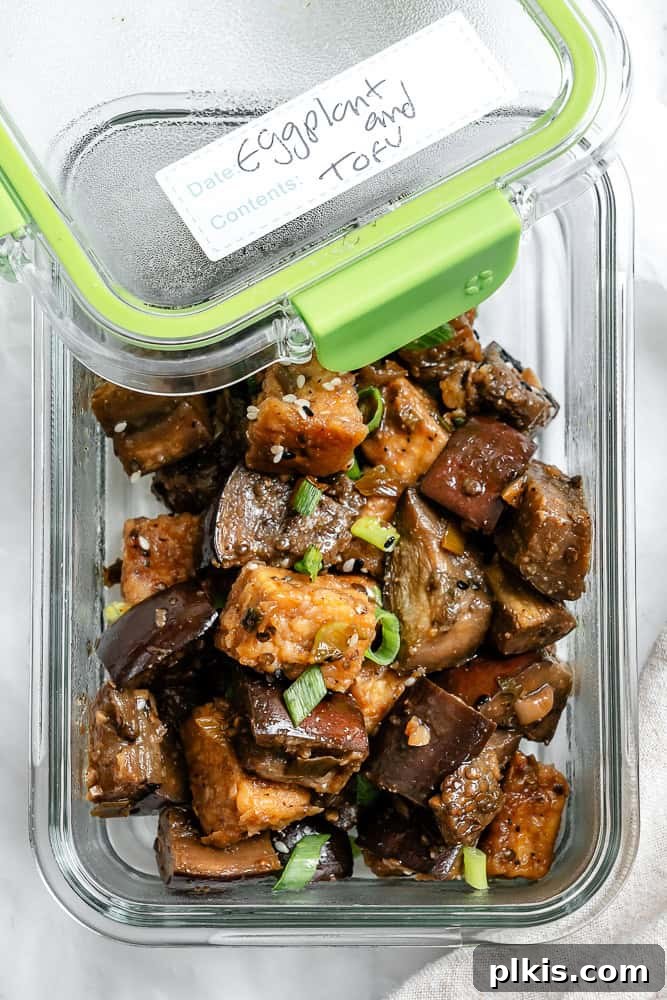 Sweet Chili Glazed Eggplant and Tofu 10 A portion of Sticky Eggplant and Tofu neatly packed into a glass meal prep container, ready for storage.