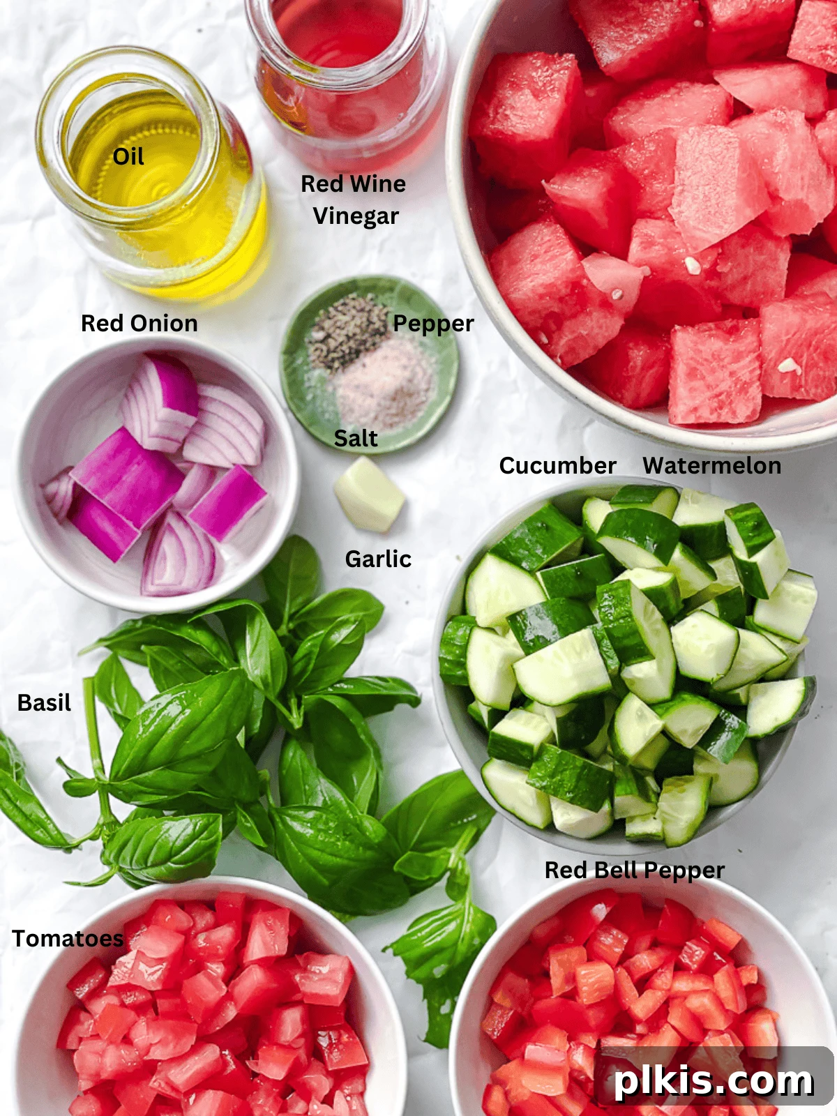 Summer Melon Chill 3 Individual bowls displaying fresh ingredients for Watermelon Gazpacho, including diced watermelon, tomatoes, cucumbers, bell peppers, onion, garlic, and basil.