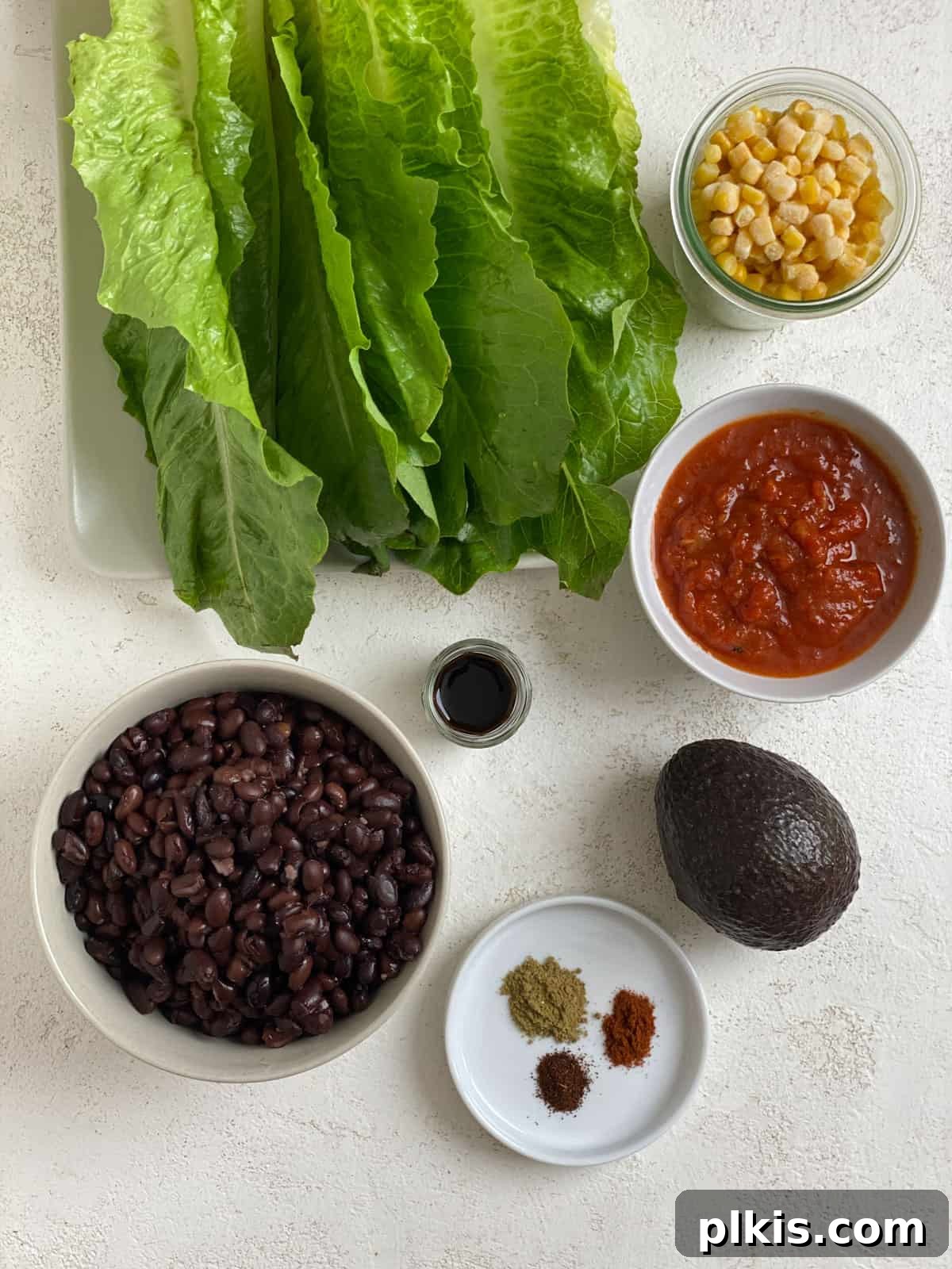 Zesty Black Bean Lettuce Cups 3 ingredients for Vegan Black Bean Lettuce Wraps measured out against a white surface