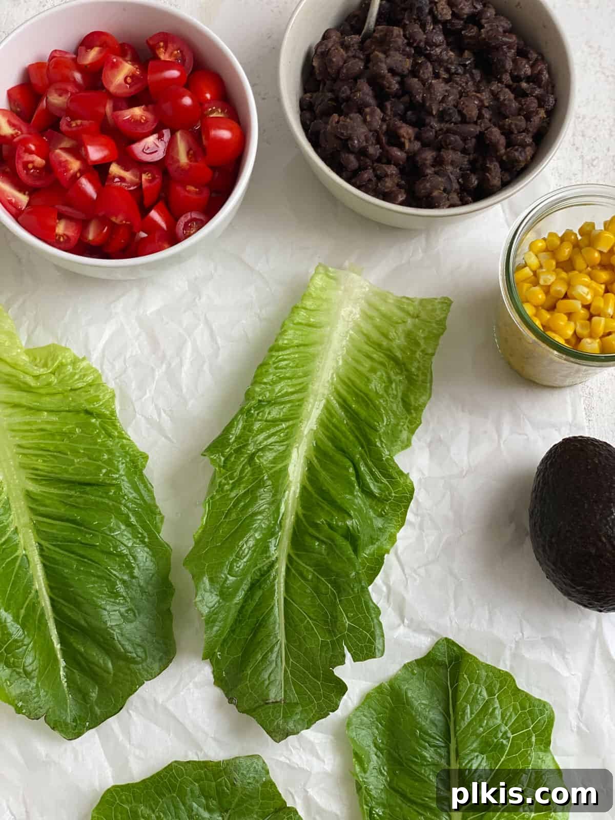 Zesty Black Bean Lettuce Cups 5 ingredients for Vegan Black Bean Lettuce Wraps measured out against a white surface