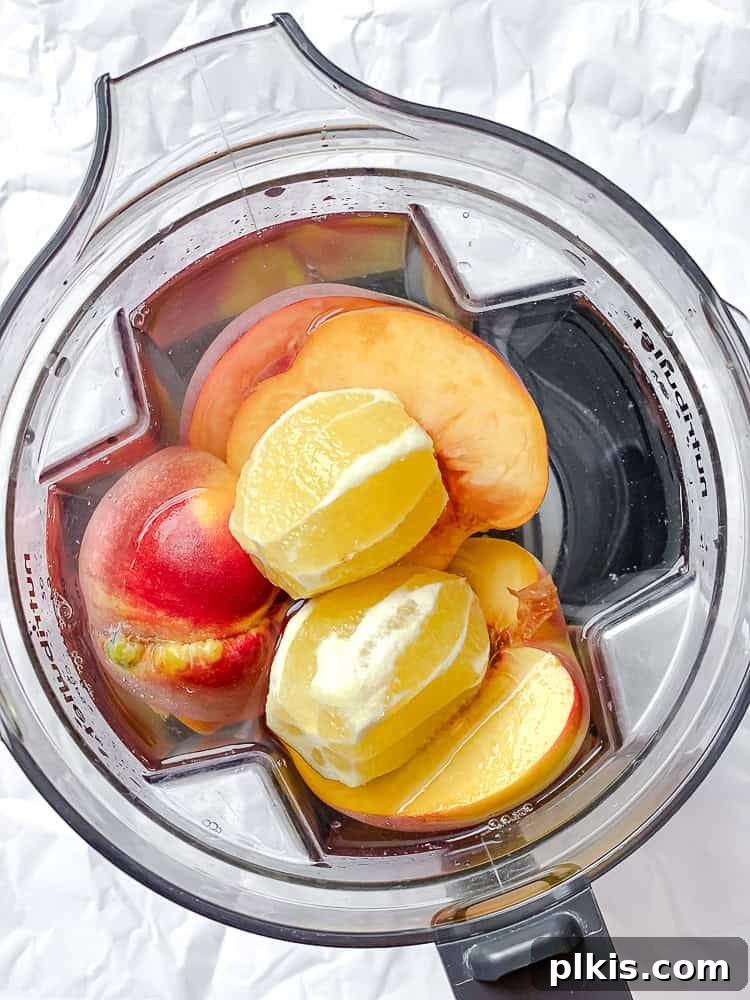 Golden Peach Lemonade 4 ingredients for peach lemonade in a blender.