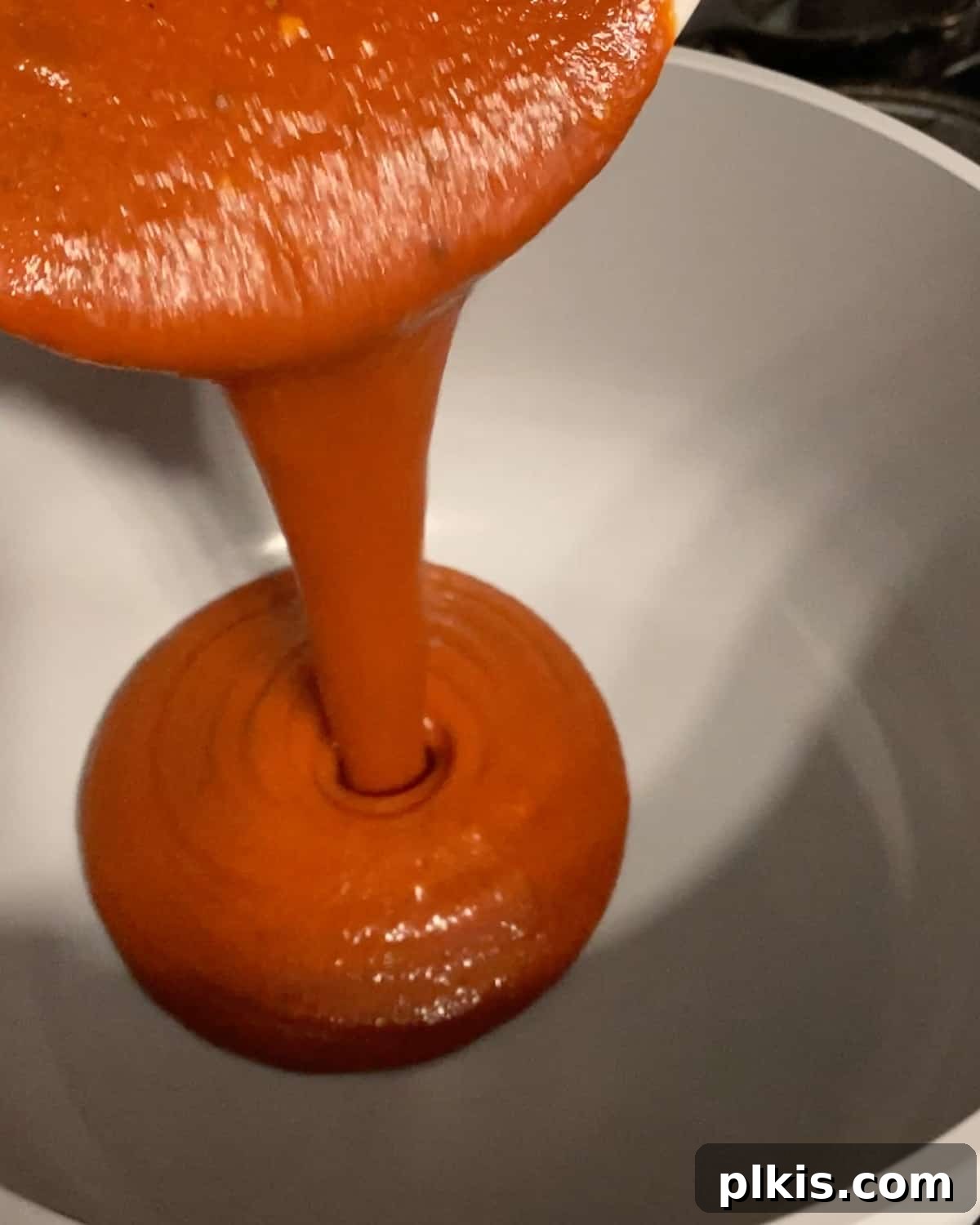 Process shot of pouring bbq sauce