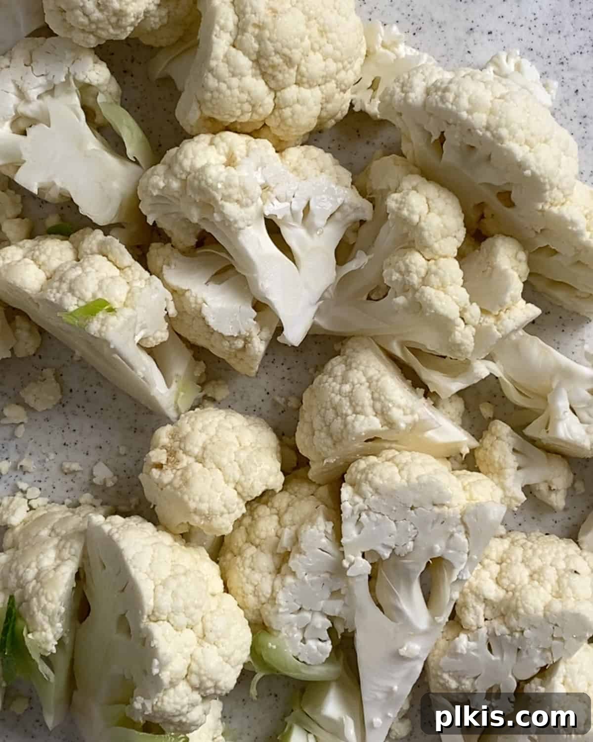 Cauliflower florets cut on a light surface
