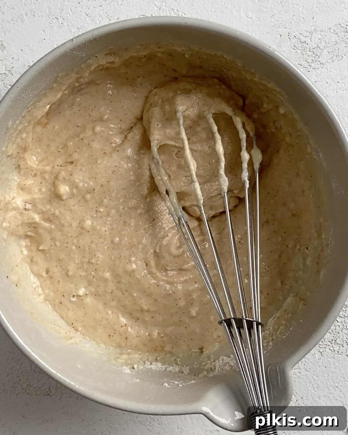 Process shot of mixing ingredients to cauliflower batter with mixer