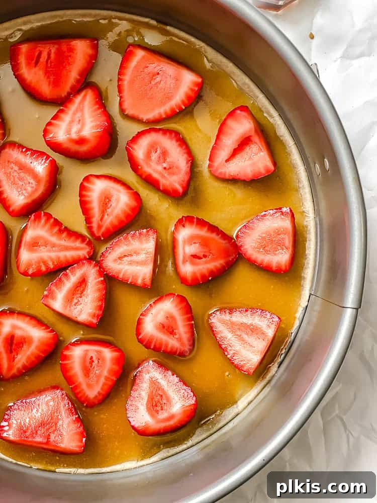 Strawberry Crown Cake 5 process shot showing strawberries added to pan, arranged beautifully over the caramel base
