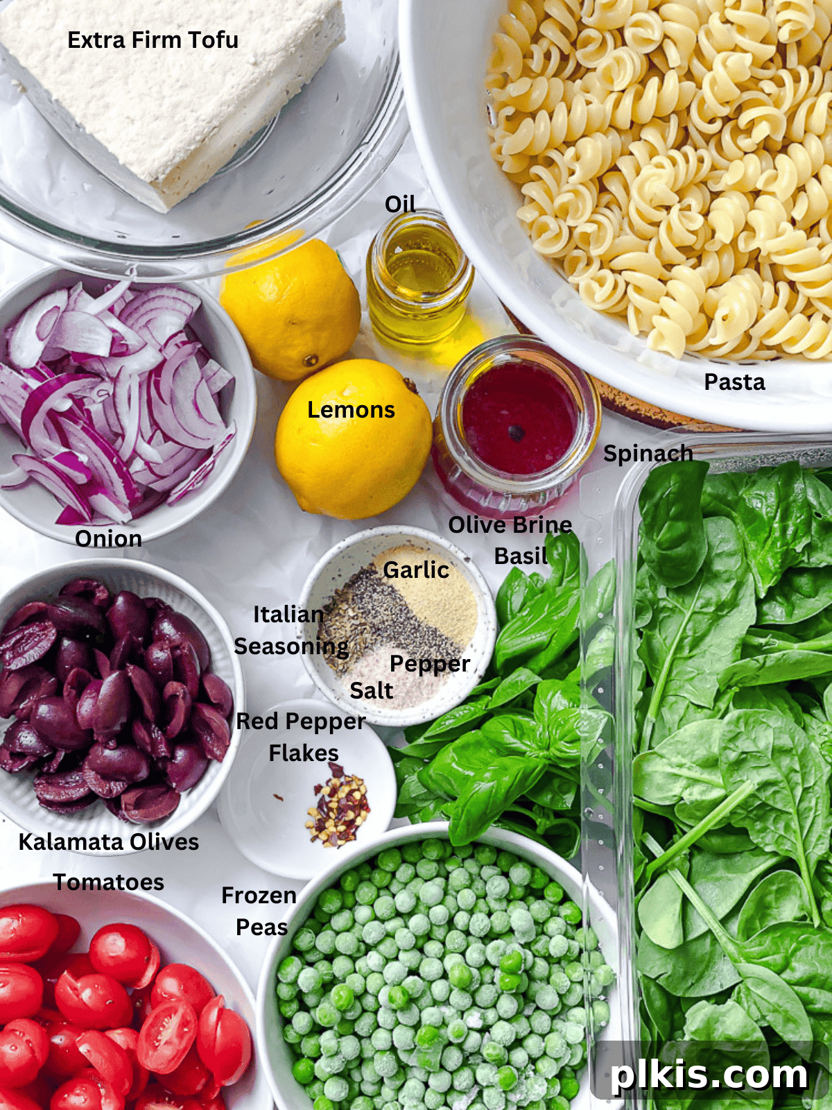 ingredients for Spinach Pasta Salad measured out on a white surface