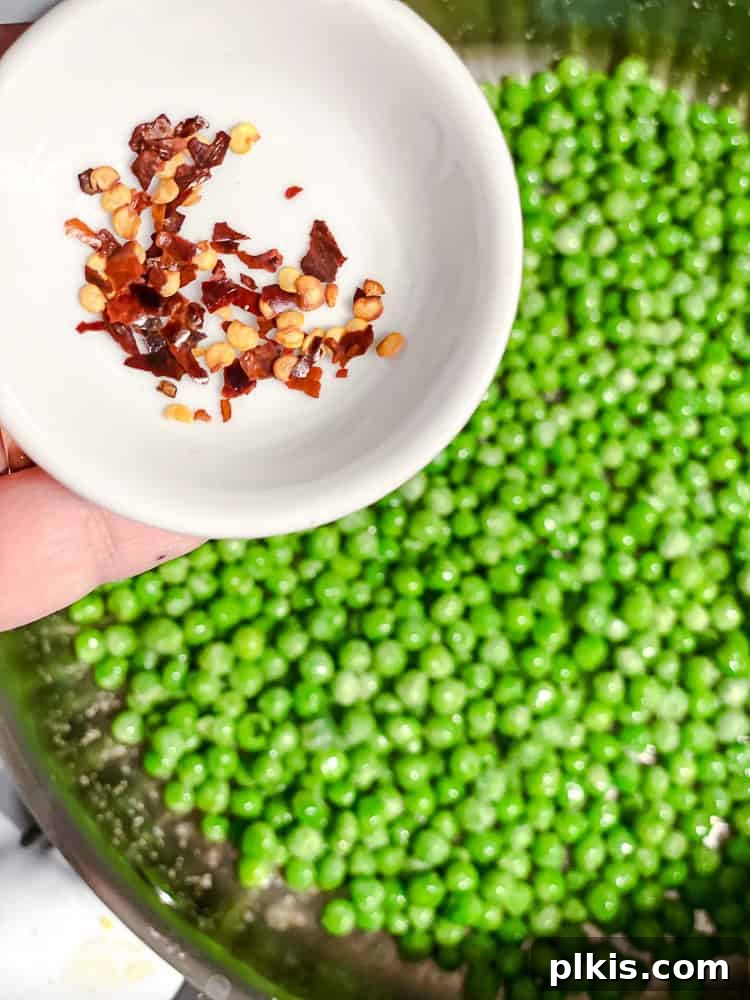 seasoning green peas with chili flakes.