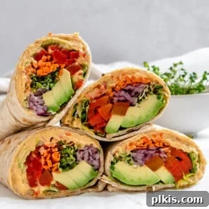 several completed Easy Hummus Tortilla Wraps on a white surface