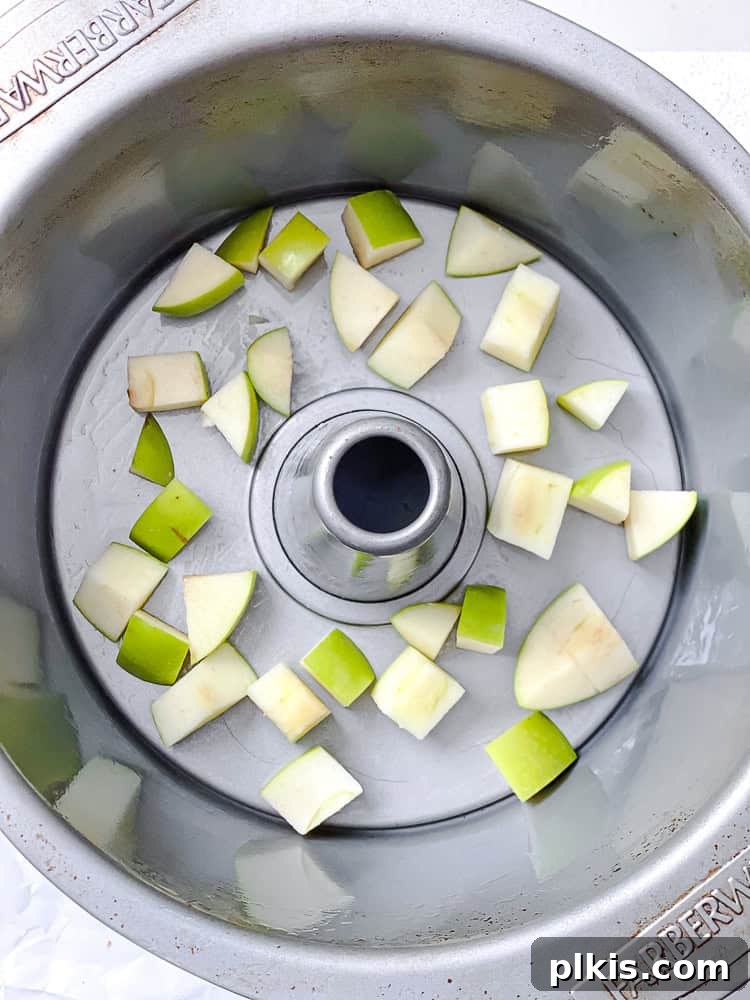 Sweet Apple Monkey Delight 4 Process shot showing the first layer of chopped apples delicately placed in a bundt pan
