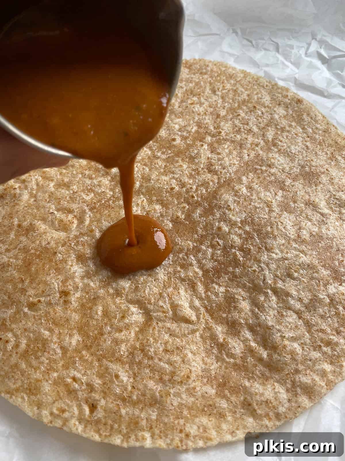 Flavor-Packed Cauliflower Wraps BBQ or Buffalo 5 Step-by-step process of preparing a vegan wrap: a hand pours delicious BBQ sauce onto a soft tortilla, the first layer of flavor for the vibrant filling.