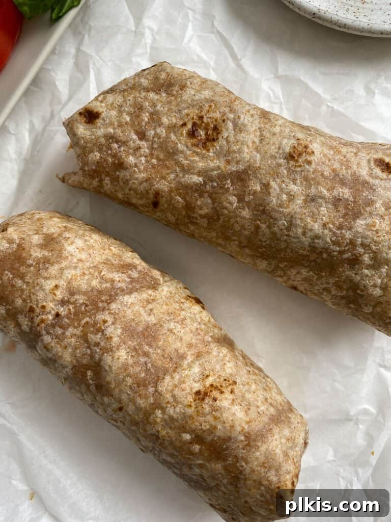 Flavor-Packed Cauliflower Wraps BBQ or Buffalo 8 Perfectly rolled BBQ or Buffalo Cauliflower Veggie Wraps neatly arranged on a light surface, showcasing their compact and delicious form, ready to be enjoyed.