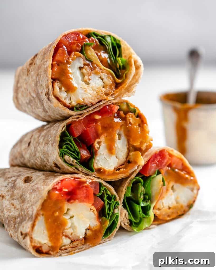 Flavor-Packed Cauliflower Wraps BBQ or Buffalo 9 Two beautifully stacked BBQ or Buffalo Cauliflower Veggie Wraps, showcasing their delicious and vibrant filling against a clean white background, perfect for a healthy and satisfying meal.