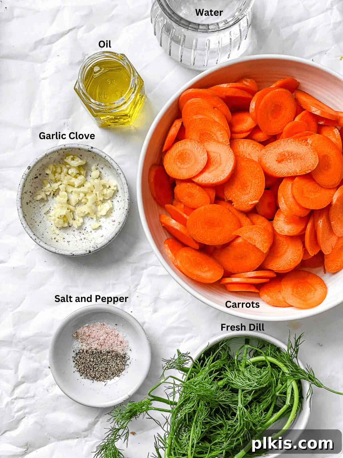 Golden Glazed Carrots 3 Ingredients for Simple Sautéed Carrots laid out on a white surface, including sliced carrots, garlic, oil, and herbs.