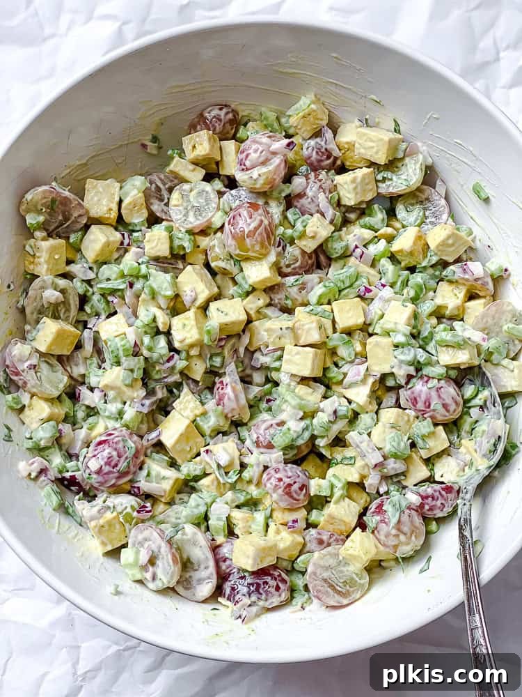 process shot showing mixing all vegan chicken salad ingredients together to combine thoroughly