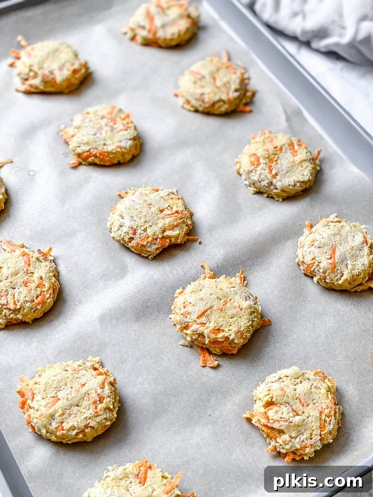 Spiced Carrot Cake Cookies 7 Process shot showing unbaked carrot cake cookie dough balls on a baking sheet, ready for the oven.