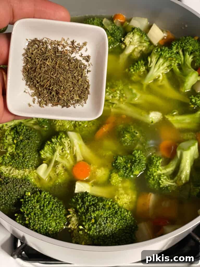 Velvety Vegan Broccoli Bliss 14 process shot of thyme being added to pot