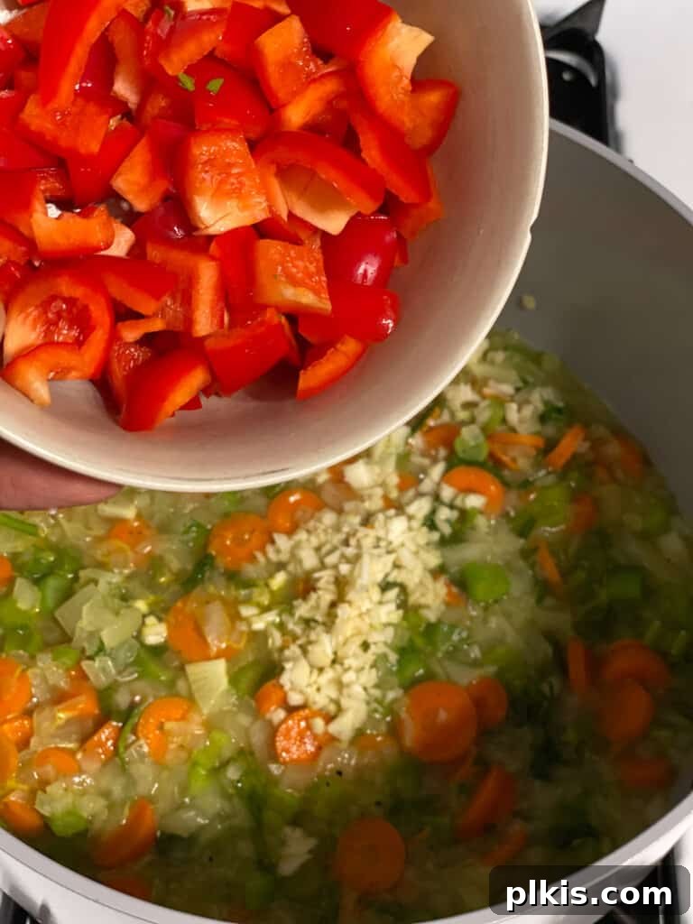 Velvety Vegan Broccoli Bliss 10 process shot of red pepper being added to pot