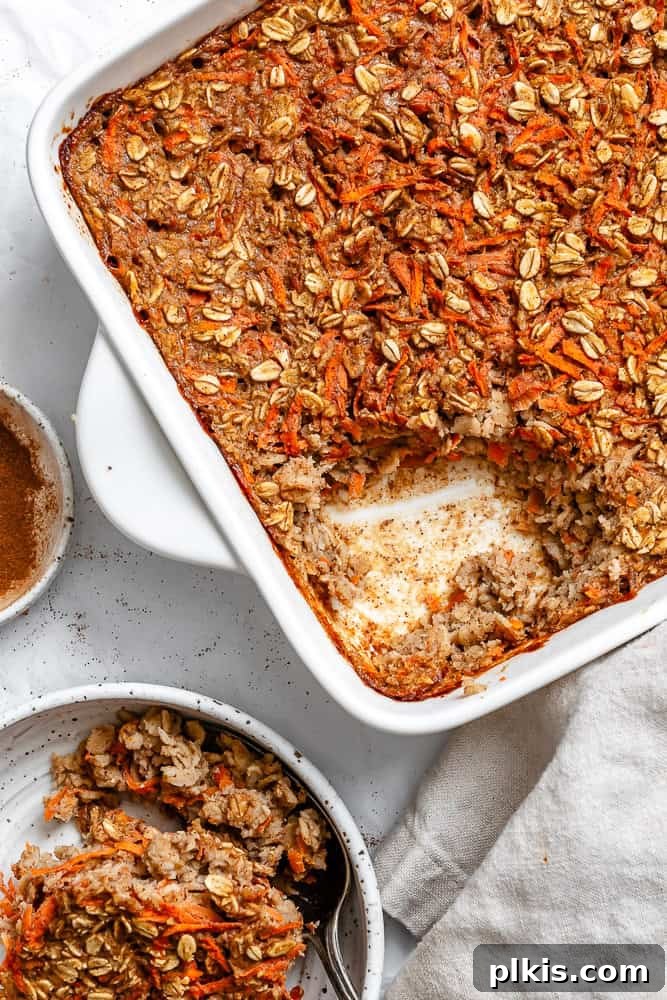 Warm Spiced Carrot Cake Baked Oats 2 Delicious and healthy Carrot Cake Baked Oats in a rustic baking dish, ready to be served for breakfast or brunch.