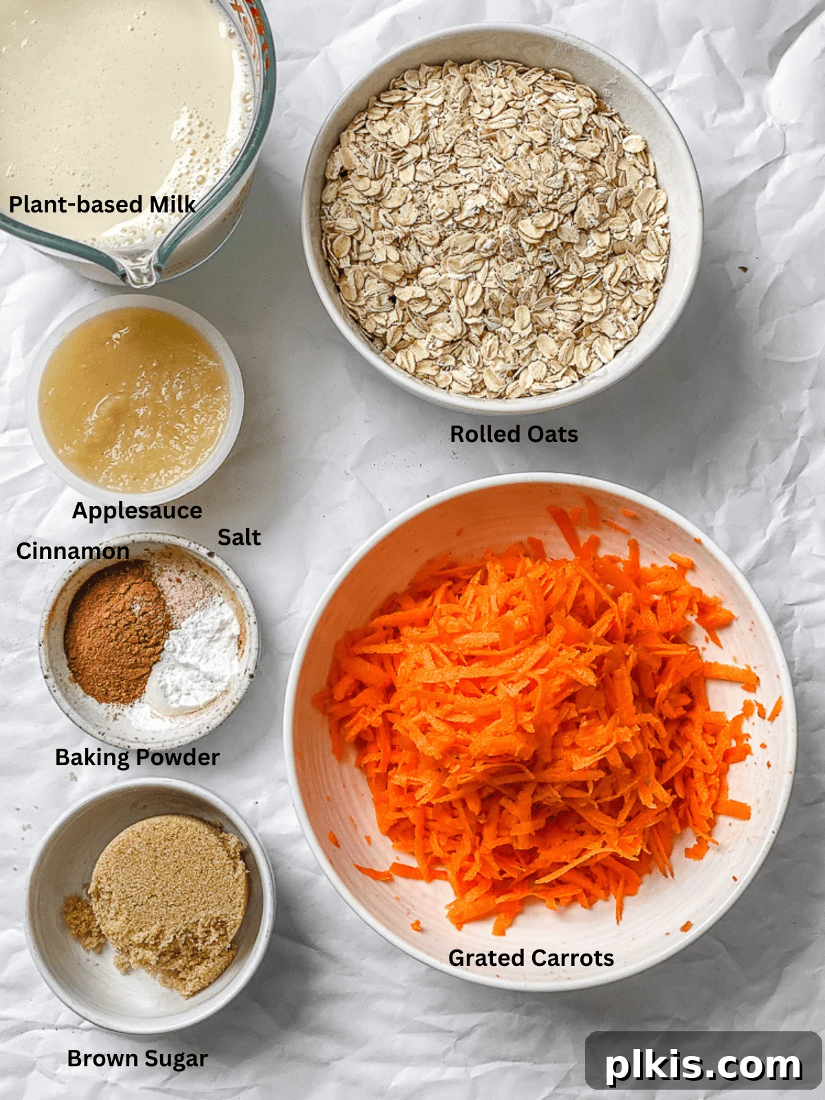 Warm Spiced Carrot Cake Baked Oats 3 A visual guide to the essential ingredients for Carrot Cake Baked Oats, neatly arranged on a white kitchen surface before preparation.