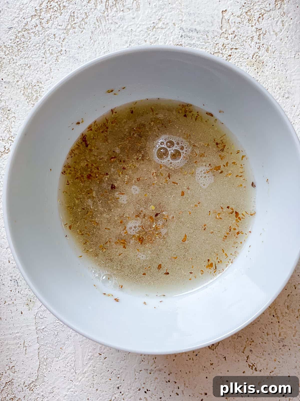 Preparing Flax Egg A small bowl containing flaxmeal mixed with water, forming a flax egg.