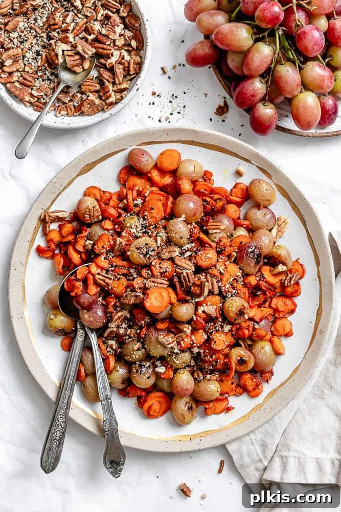 California Carrot & Grape Medley 2 A beautifully presented Carrot Grape Side Dish on a white plate, showcasing the vibrant colors of roasted carrots and grapes, garnished with a nutty topping.