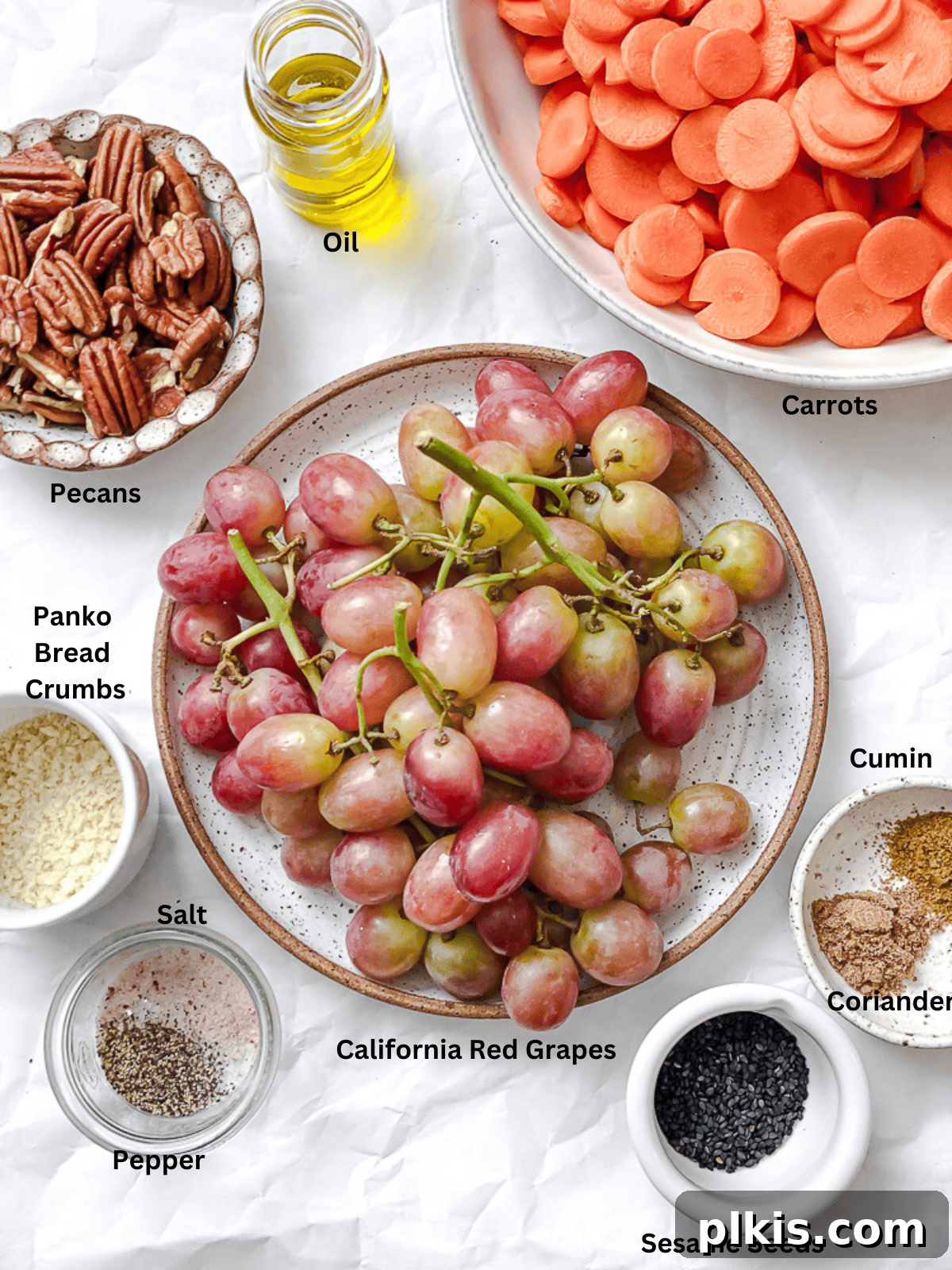 California Carrot & Grape Medley 3 All ingredients for Carrot Grape Side Dish laid out on a white surface, meticulously measured and ready for preparation.