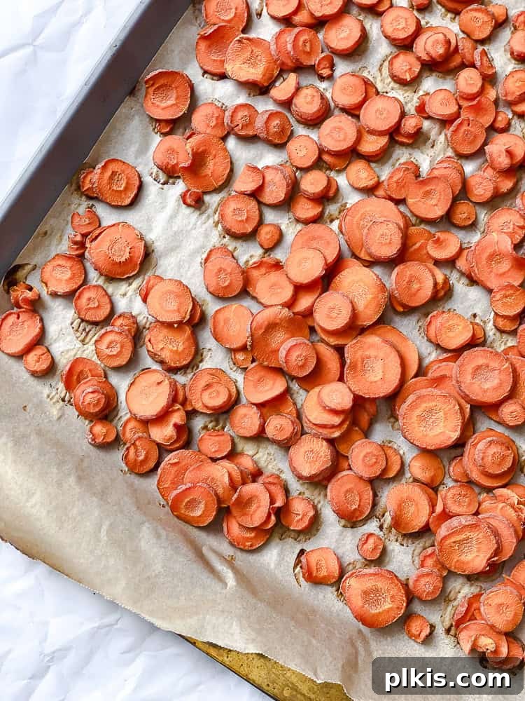 California Carrot & Grape Medley 4 Process shot showing sliced carrots evenly spread on a baking sheet, ready for the oven.