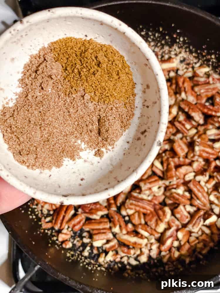 California Carrot & Grape Medley 6 Process shot showing nuts and sesame seeds toasting in a pan on the stovetop, starting to brown lightly.