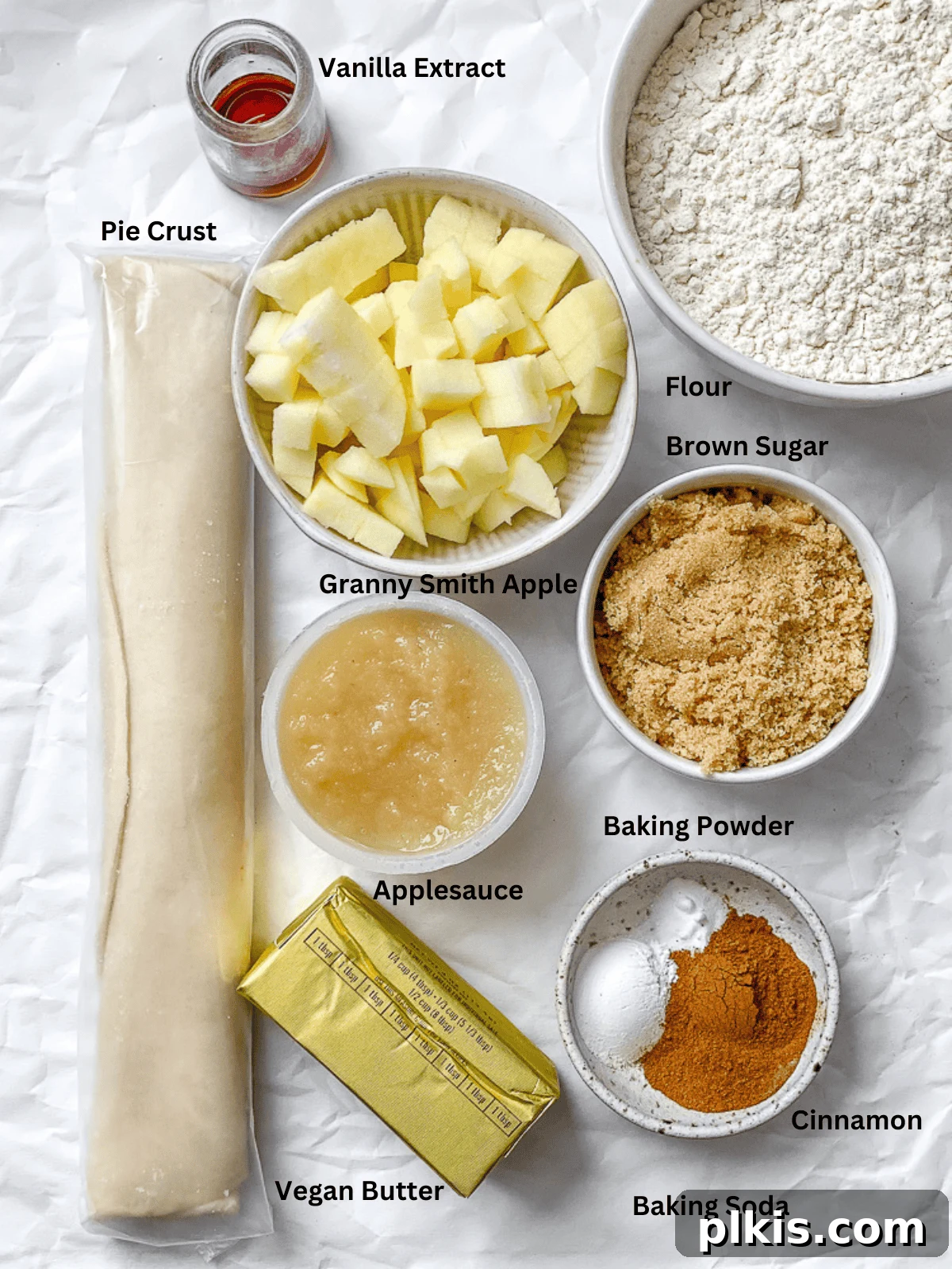 Spiced Apple Pie Cookies 3 Ingredients for Apple Pie Cookies meticulously measured out on a pristine white surface, ready for baking.