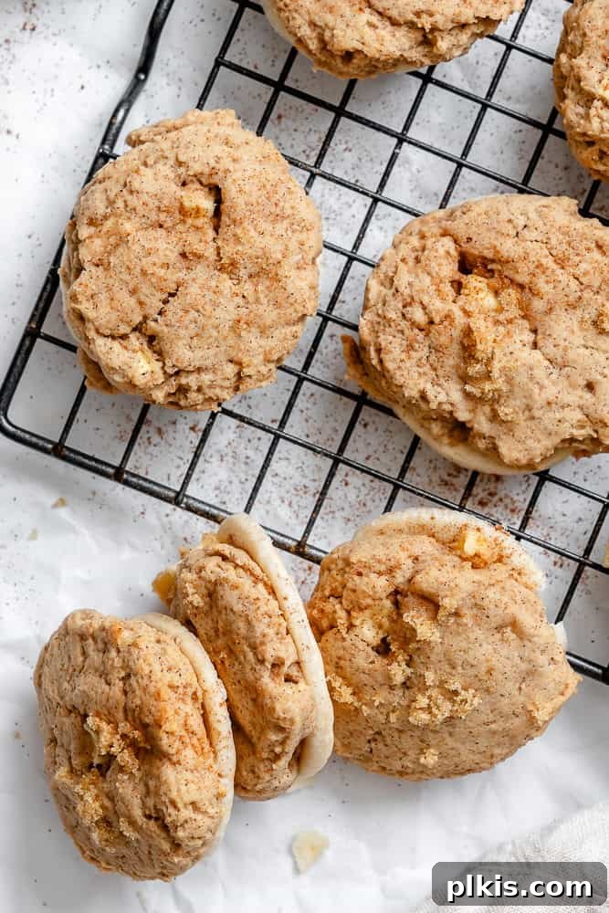 Spiced Apple Pie Cookies 8 Freshly baked Apple Pie Cookies cooling on a wire rack, steam gently rising, promising a delicious treat.