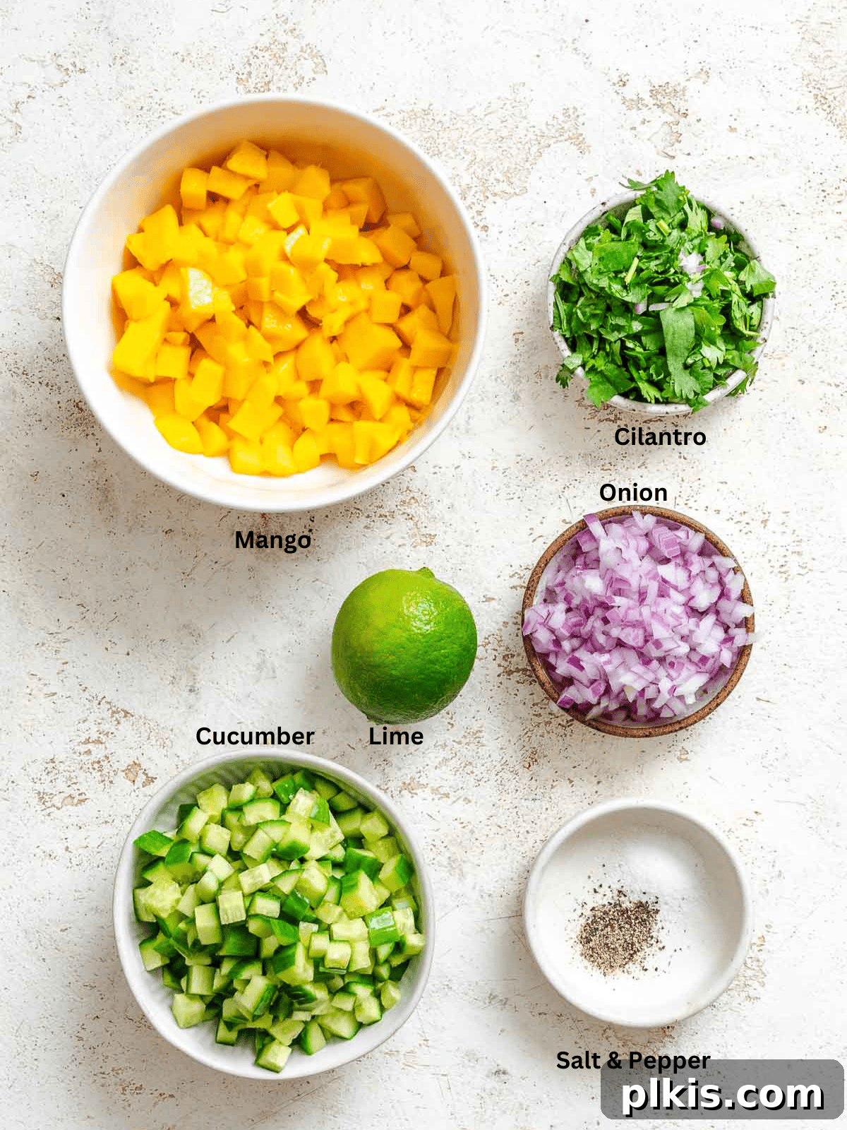 Sunshine Mango Cucumber Salsa 3 Ingredients for Mango Cucumber Salsa measured out on a white surface, ready for preparation.