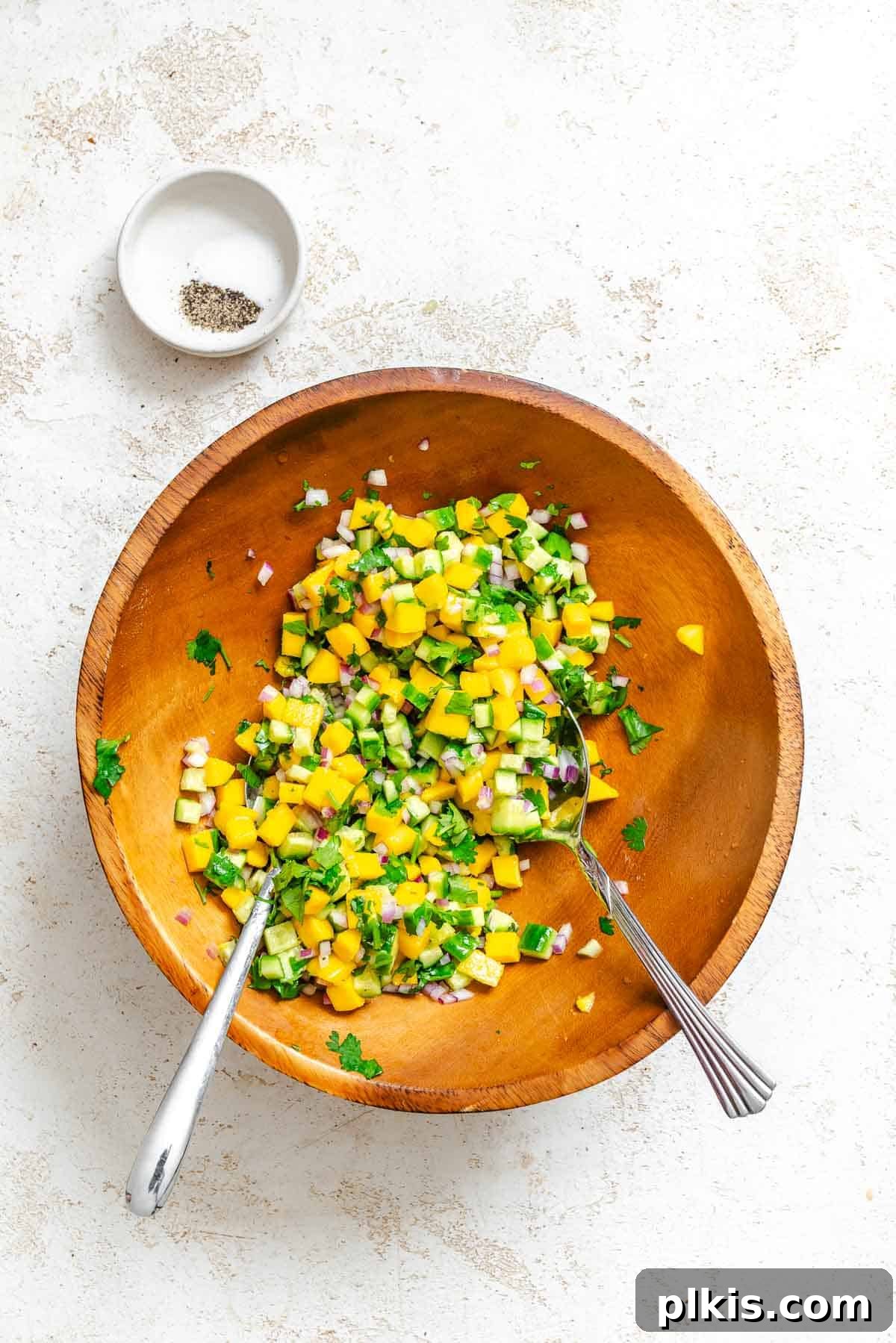 Sunshine Mango Cucumber Salsa 5 Process shot showing mixed ingredients in a bowl, colorful and ready.