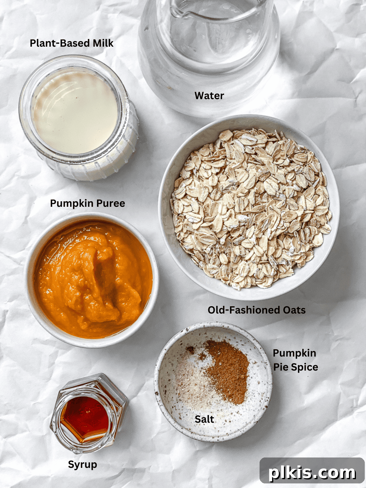 Cozy Autumn Pumpkin Oatmeal 3 All the fresh ingredients for Easy Pumpkin Oatmeal, neatly measured and laid out on a clean white surface.
