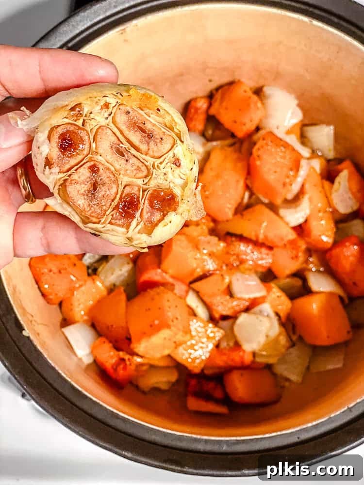Golden Harvest Bisque 5 process shot of adding roasted garlic to pot with other ingredients