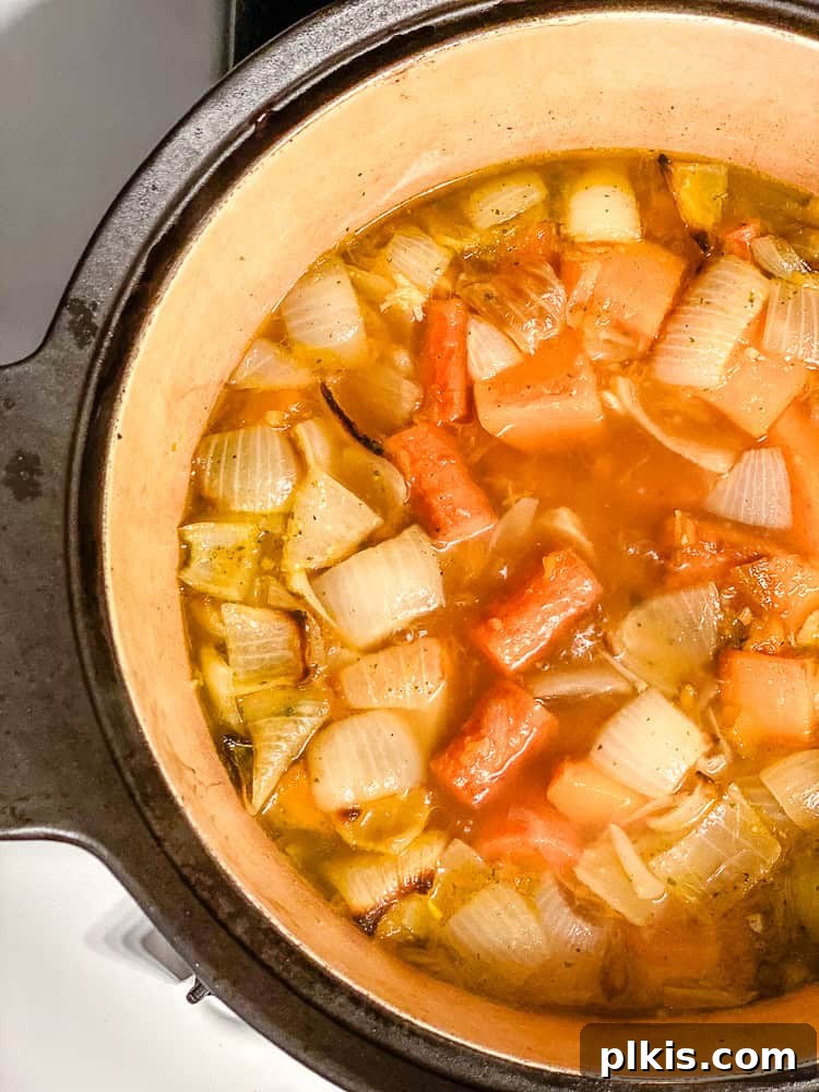 Golden Harvest Bisque 6 process shot showing roasted ingredients simmering in pot with broth