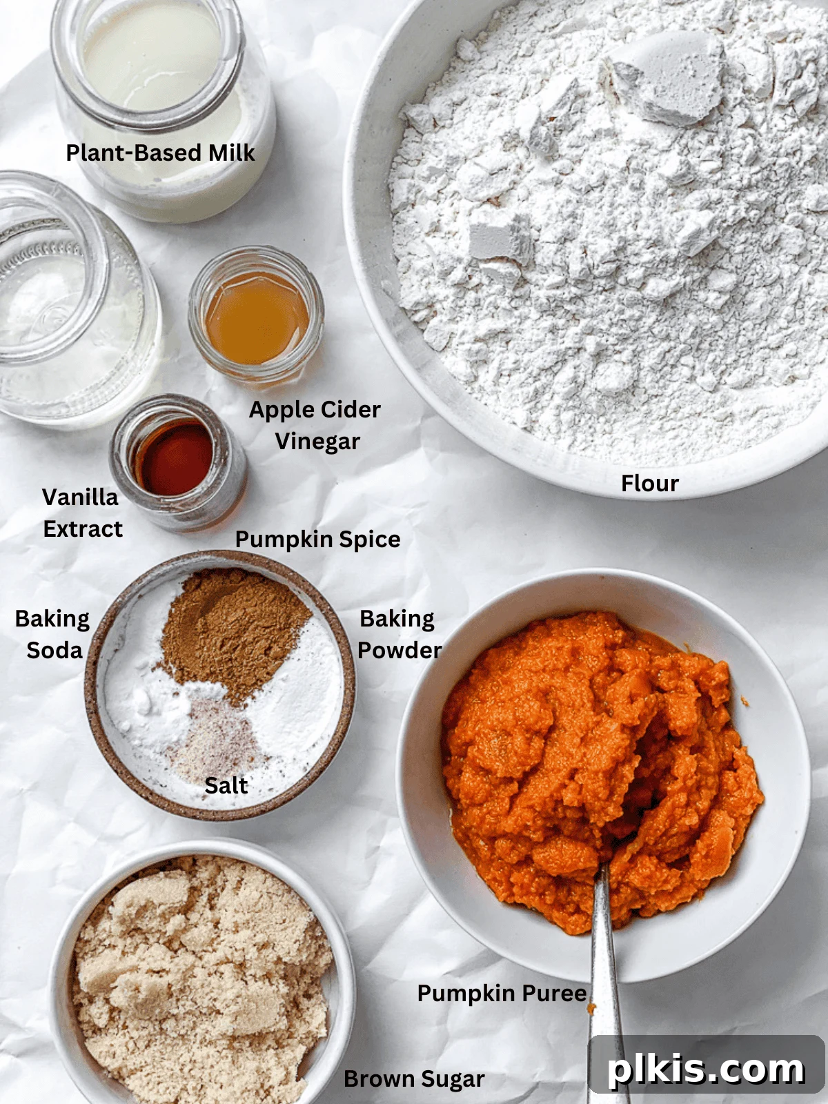 Pumpkin Spice Streusel Coffee Cake 3 Carefully measured ingredients for vegan Pumpkin Coffee Cake laid out on a white surface, including pumpkin puree, flour, spices, and plant-based milk.
