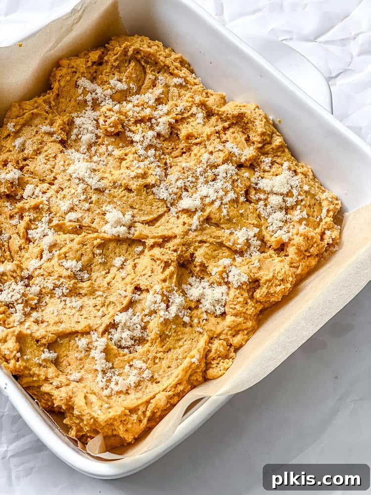 Pumpkin Spice Streusel Coffee Cake 7 Final step of baking: a golden-brown vegan Pumpkin Coffee Cake, fresh from the oven, cooling in a white ceramic baking dish.